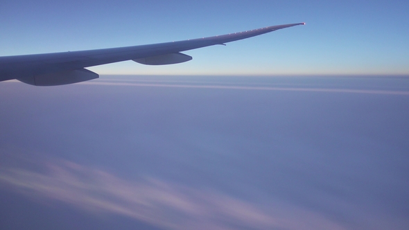 Looking on Wing and Fumes of Flying Airplane alt