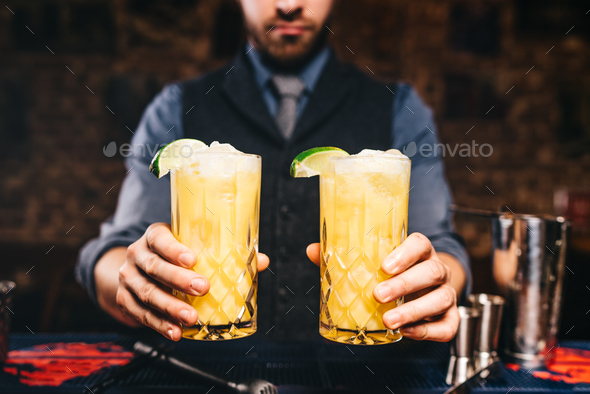 close up portrait of bartender or barman serving fresh drinks Stock Photo by stockcentral