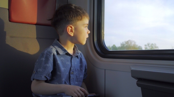 The Boy Is On the Train, Playing Games on the Tablet