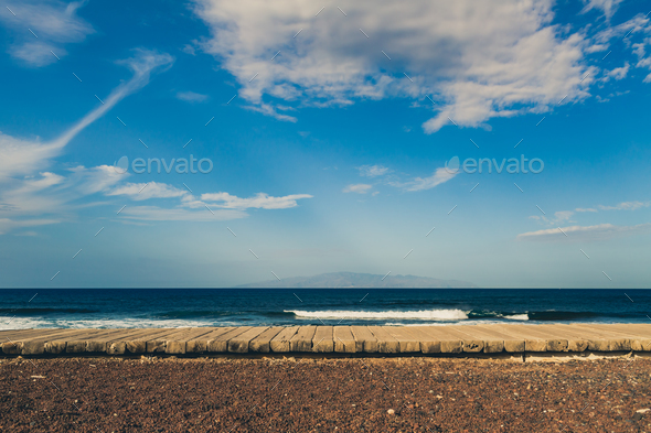 Inspirational landscape, wooden sidewalk on beach, Tenerife coas Stock Photo by blas