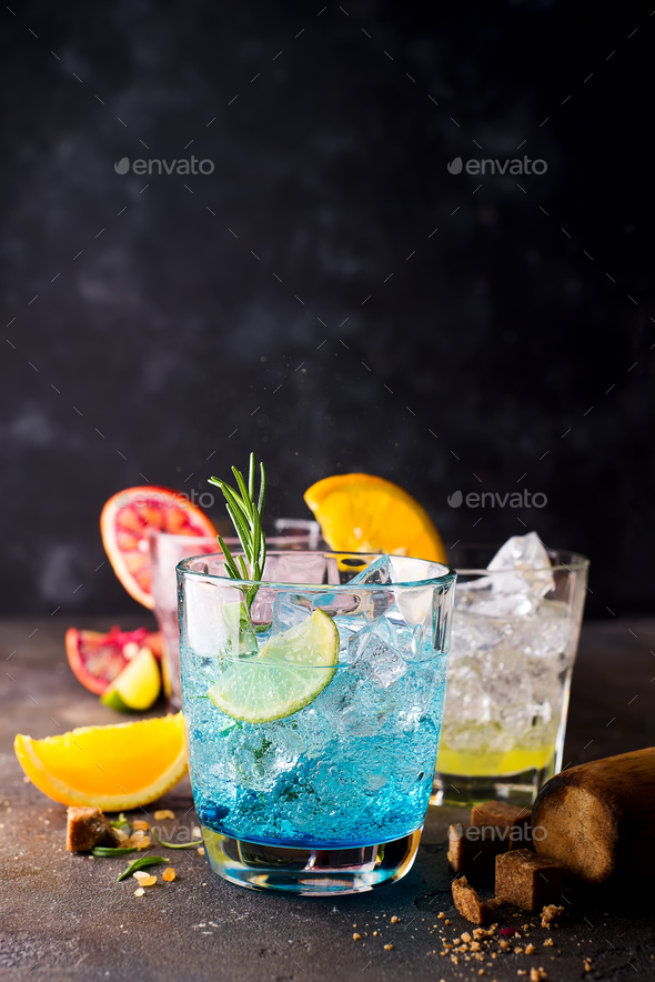 Blue Hawaiian Lagoon Cocktail with malibu rum, blue curacao, vodka, tequila,orange juice and mint Stock Photo by lyulkamazur