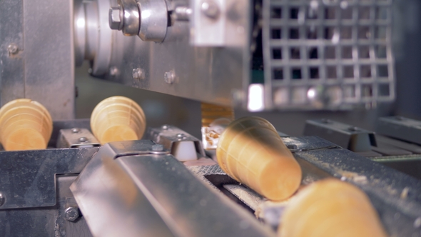 Waffle Cups Are Getting Removed From the Conveyor Belt To the Metal Duct alt