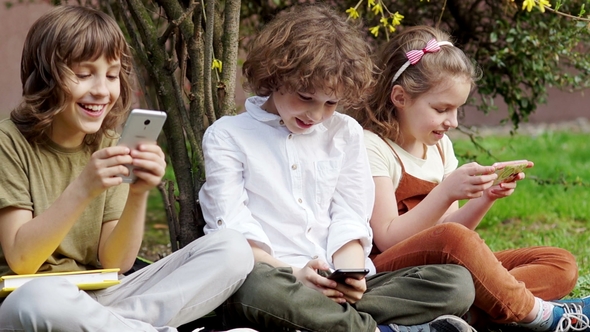 Children, Boys and Girl, Brother and Sister Are Sitting on the Grass and Playing alt