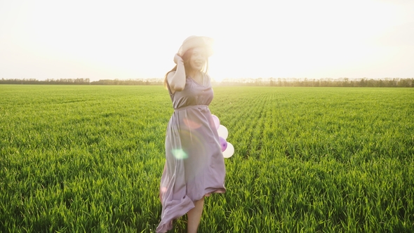 Beauty Girl Running on Spring Field with Colorful Air Balloons