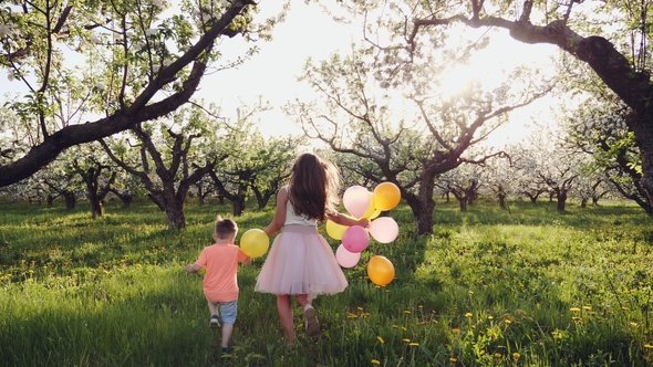 Children Running in a Blooming Garden at Sunset alt
