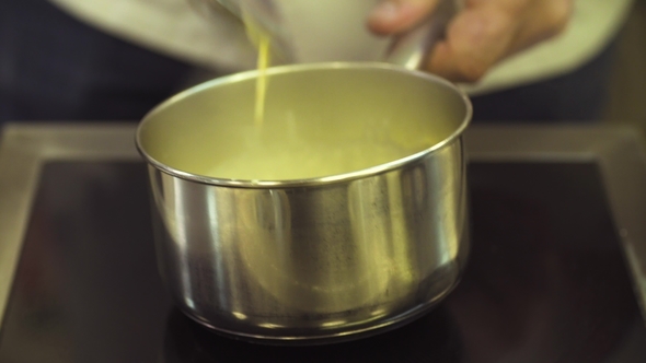 Hands Mixing Sauce Preparing in a Saucepan