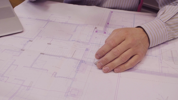 The Engineer's Hand Correcting the Drawing