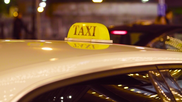 Taxi in Moscow on the Blurred Lights Background
