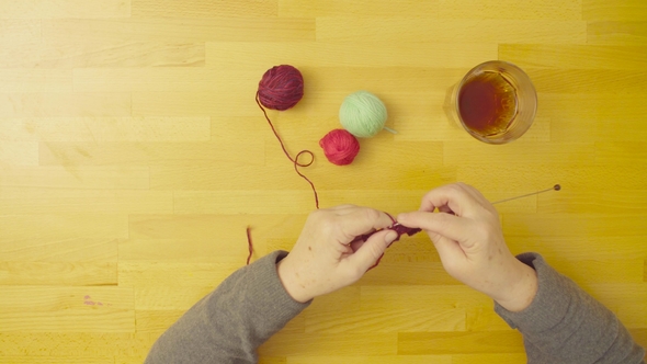 Hands of Senior Woman Knitting Wool