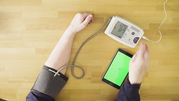 Senior Woman Measuring Her Own Blood Pressure