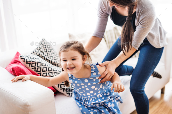 Young mother with a small girl at home. - Stock Photo - Images
