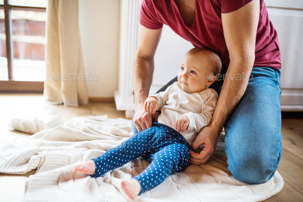 Father with a baby girl at home. - Stock Photo - Images