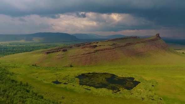 Aerial View of the Green Fields of Mountain Range Sunduki before the Storm
