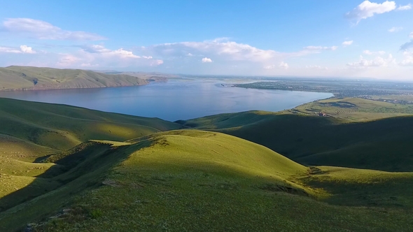 Aerial View of the Green Hills, Cloudy Sky and the Yenisei River