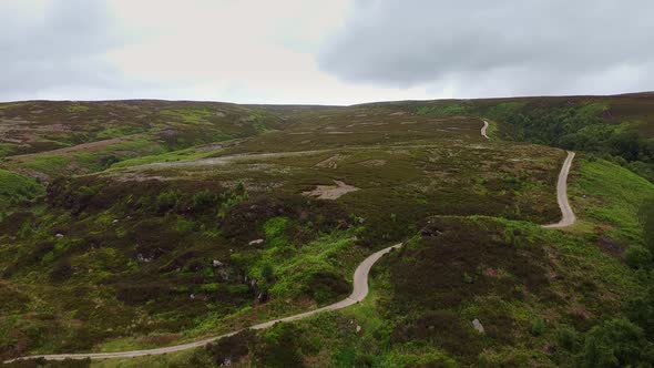 Drone ariel point of view.  Derbyshire Peak District moorlands with winding pathways. alt