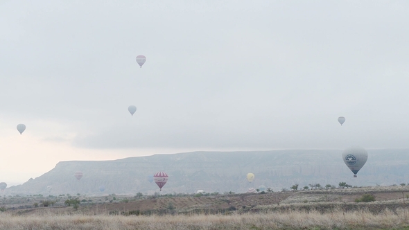 Balloons Float Through the Sky. Tourists From Around the World Come To Cappadocia To Tour the