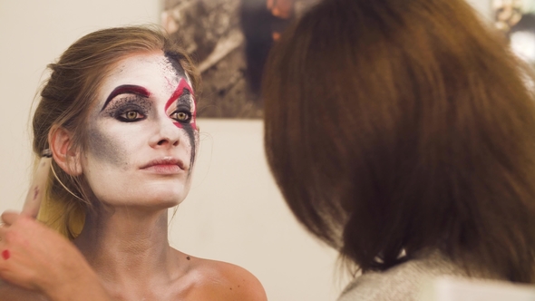 Makeup Artist Drawing on the Model's Face