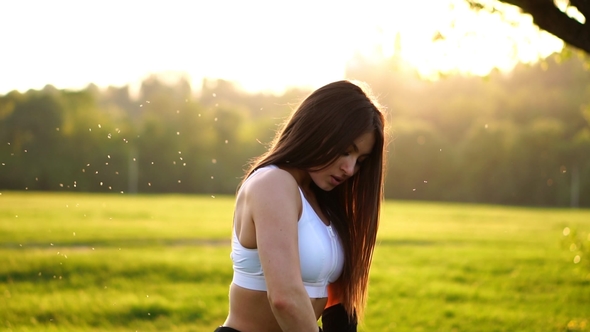 Young Beautiful Woman Listening Music at Park while Running alt