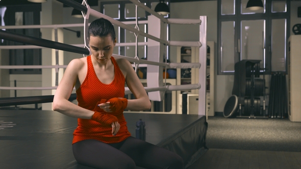 Female Boxer Preparing for Training alt