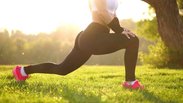 Slim Athletic Woman Working out in Park Doing Knee-bounce Exercise or ...