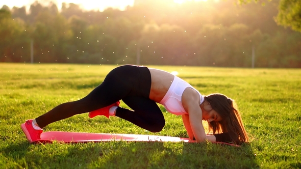 Slim Athletic Woman Working out in Park Doing Knee-bounce Exercise or ...