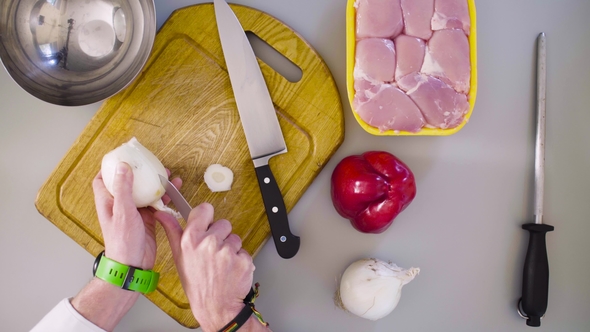 Chef Cooking a Chicken Dish and Cutting Onion