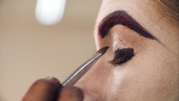 Makeup Artist Applying Eyeshadow on the Eyes