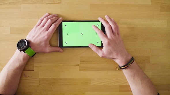 Male Hand Scrolling a Tablet with Green Screen