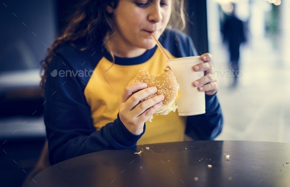 Close up of teenage girl eating hamburger obesity concept Stock Photo by Rawpixel