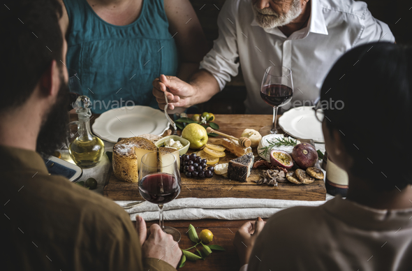 People enjoying a cheese platter food photography recipe idea - Stock Photo - Images
