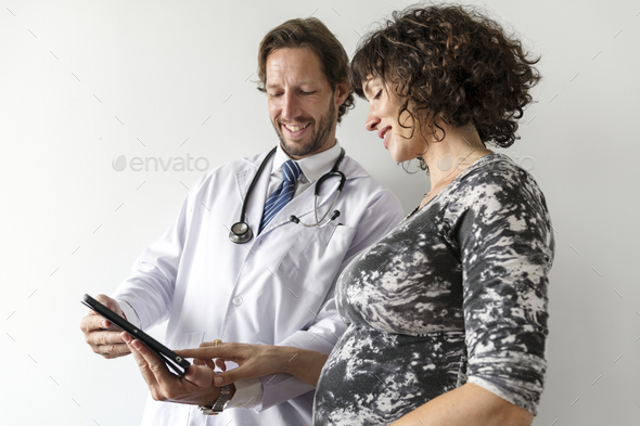 Pregnant woman having fetal monitoring by doctor - Stock Photo - Images