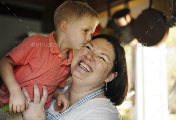 Son kissing mommy in the kitchen Stock Photo by Rawpixel | PhotoDune