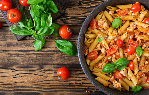Penne pasta in tomato sauce with chicken - Stock Photo - Images