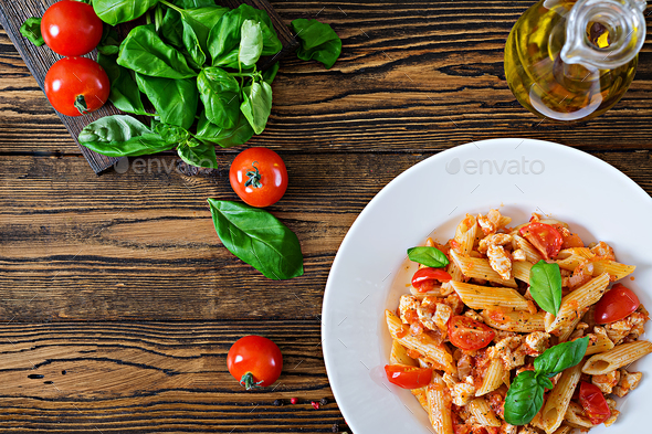 Penne pasta in tomato sauce with chicken, - Stock Photo - Images