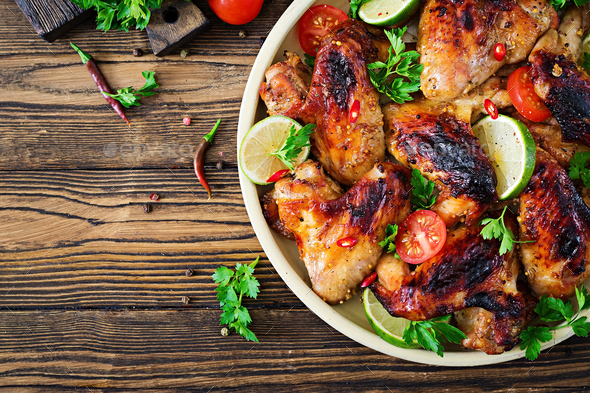 Chicken wings of barbecue in sweetly sour sauce. Picnic. Summer menu. Tasty food. Top view. Flat lay Stock Photo by Timolina