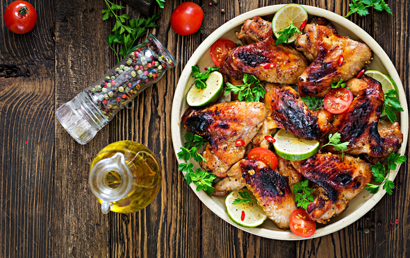 Chicken wings of barbecue in sweetly sour sauce. Picnic. Summer menu. Tasty food. Top view. Flat lay Stock Photo by Timolina