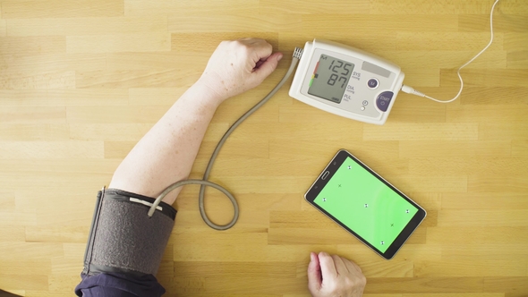 Senior Woman Measuring Her Own Blood Pressure