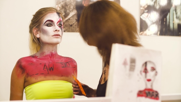 Makeup Artist Drawing on the Model's Face