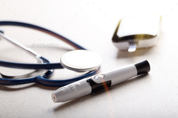 Personal blood glucose meter and lancet with stethoscope on the - Stock Photo - Images