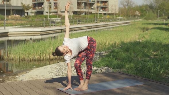 Young Woman Doing Yoga in Park alt