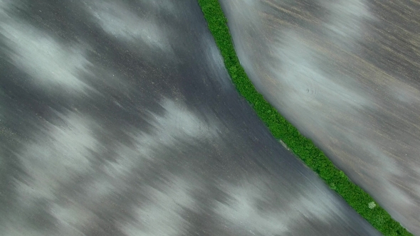 Texture of Plowed Field,  Aerial View Green Border Between Two Plowed Field Before Planting.