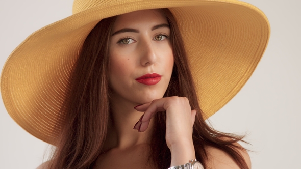 Portrait of Woman with Large Straight Hair Wears Big Summer Yelow Hat