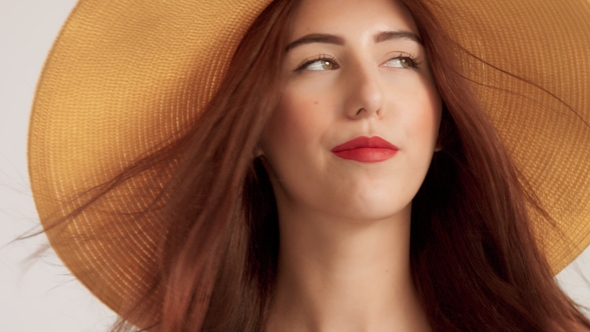 Portrait of Woman with Large Straight Hair Wears Big Summer Yelow Hat