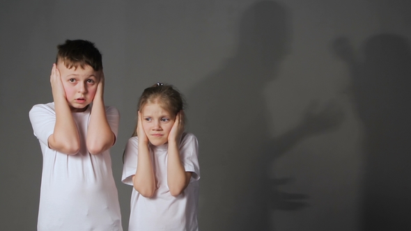 Little Boy and Girl and Silhouettes of Quarreling Parents on Background