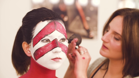 The Makeup Artist Drawing the Outline of the Eyes alt