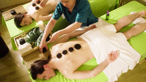Two Therapists Doing Chinese Stone Therapy