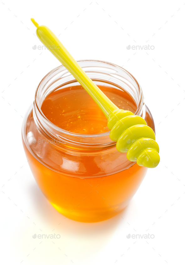 glass jar full of honey and stick - Stock Photo - Images