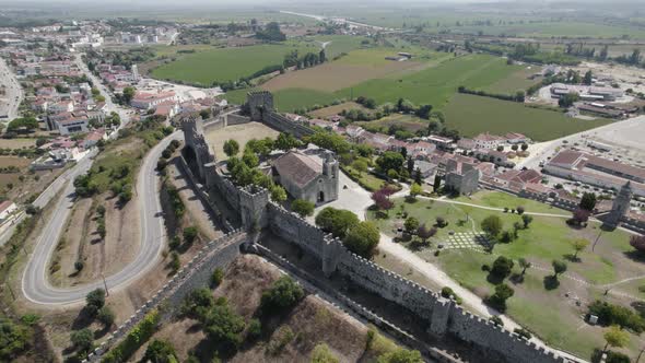 High view Montemor-o-velho castle on hill surrounded by green rice fields, Portugal