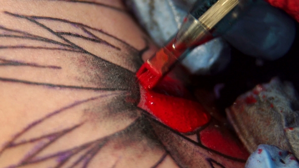 Professional Tattooist Doing Tattooing in Studio. alt