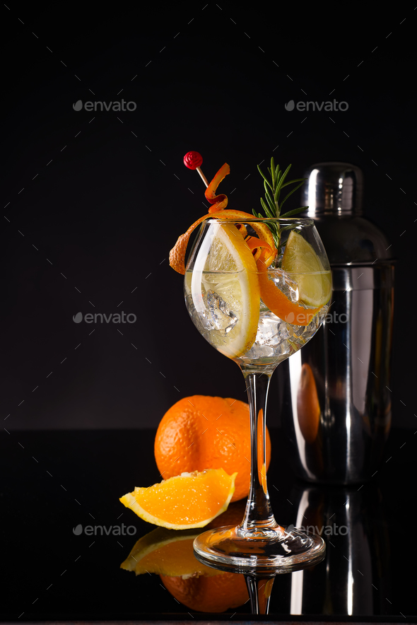 Glass of a cold cocktail drink with white wine served with brown sugar, orange and shaker - Stock Photo - Images